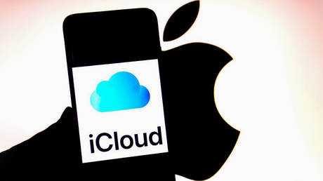 FILE PHOTO: An iCloud logo is seen displayed on a smartphone with an Apple logo in the background.