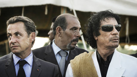 FILE PHOTO: Former French President Nicolas Sarkozy and the late Libyan leader Muammar Gaddafi in Tripoli on July 25, 2007.