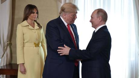 FILE PHOTO: Russian President Vladimir Putin and US President Donald Trump, center, with his wife, Melania, during a meeting at the Presidential Palace in Helsinki.