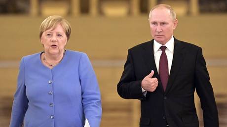 FILE PHOTO: Angela Merkel and Vladimir Putin.