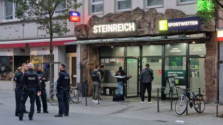 Police officers stand in the market square in Giessen, Germany, October 11, 2025.