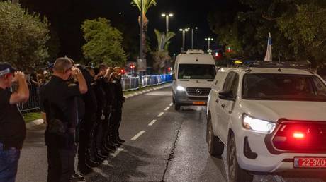 Israeli officers pay their respects as the bodies of four hostages arrive from Gaza.