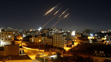FILE PHOTO: Streaks of light from Iranian ballistic missiles are seen in the night sky, as Iran resumes its retaliatory strikes against Israel, June 15, 2025.