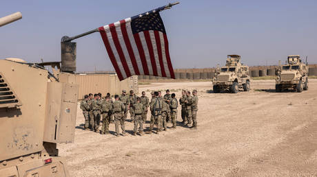 FILE PHOTO. US Army soldiers prepare to go out on patrol in northeastern Syria.