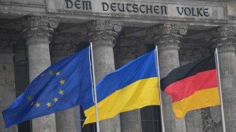 FILE PHOTO. The flags of the EU, Ukraine and Germany fly in front of the Reichstag in Berlin, Germany.