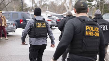 FILE PHOTO. Federal agents  walk through a parking lot in Bloomington, Minnesota.