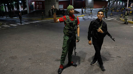 Members of the presidential guard stand outside the Miraflores presidential palace after explosions and low-flying aircraft were heard in Caracas, Venezuela, Jan. 3, 2026.