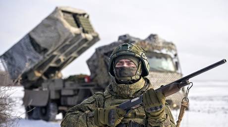 A Russian serviceman of 45th Separate Guards Engineering Brigade of the Zapad (West) Group of Forces serving a Zemledeliye remote mine-laying system monitors the sky to detect and destroy enemy drones during a combat training.