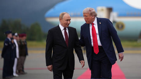 FILE PHOTO: Russian President Vladimir Putin and his US counterpart Donald Trump talking during their meeting in Anchorage, Alaska.