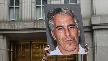 A protester holds a picture of Jeffrey Epstein outside a New York courthouse. July 8, 2019.